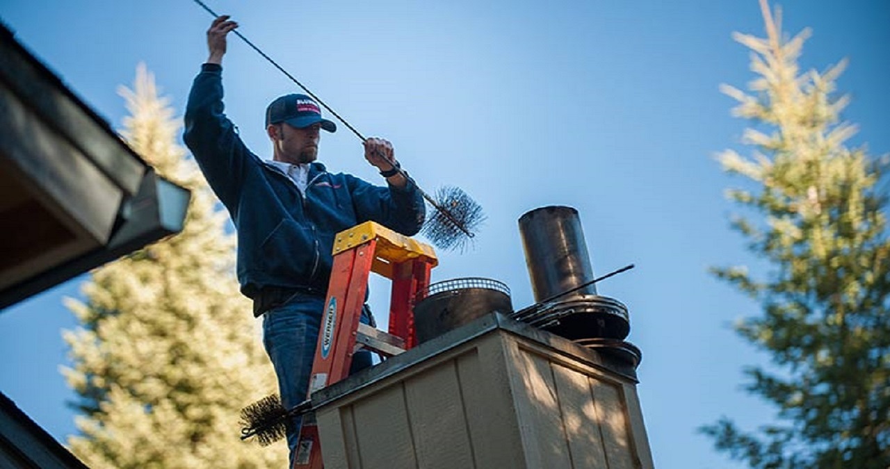 Experienced chimney sweep in San Francisco, CA, conducting a professional cleaning of a residential chimney.