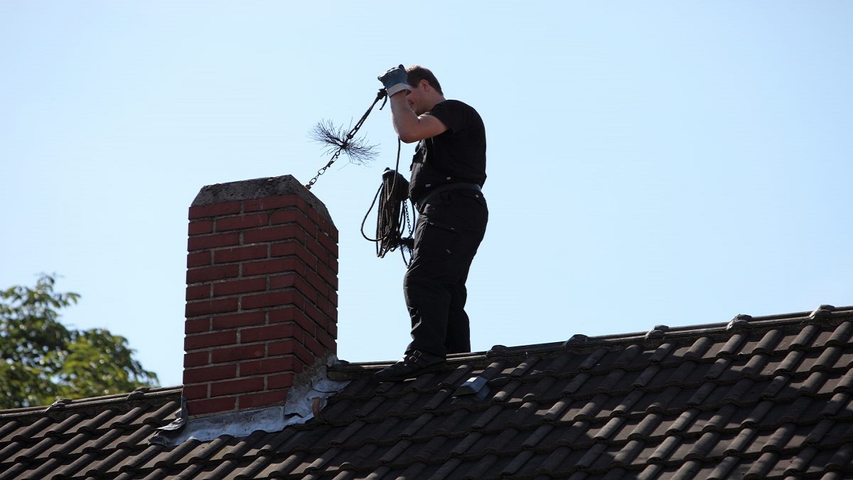 Professional chimney cleaners in San Francisco, CA performing a thorough inspection and cleaning of a residential chimney.